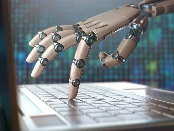 Robotic hand typing on a laptop keyboard with digital background.